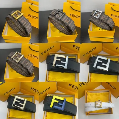 Leather belts with large metal buckles beside yellow gift boxes