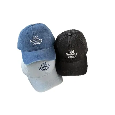 Two washed denim baseball caps with embroidered text
