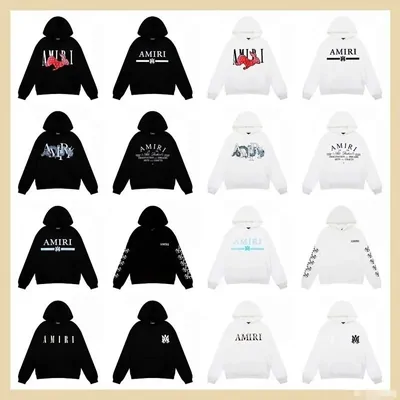 Black and white pullover hoodies with a printed logo, laid out in rows