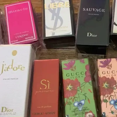 Boxed perfumes in pink, red and green packaging on a table