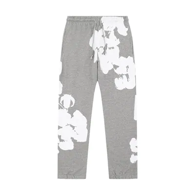 Grey sweatpants with a large white floral print down one leg