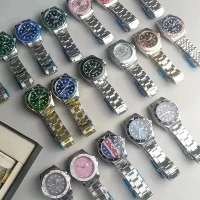 Rows of steel bracelet watches with green, blue and pink dials